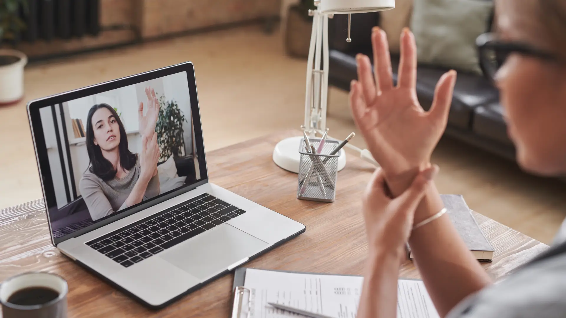 modern-young-adult-female-doctor-sitting-desk-front-laptop-working-with-patient-online-v